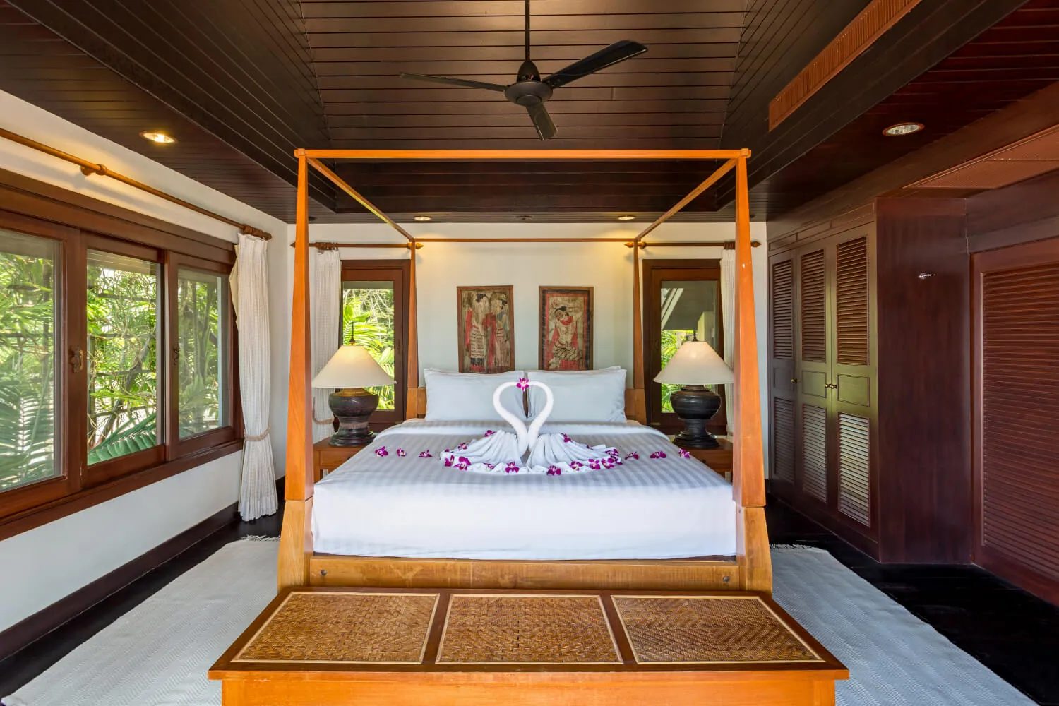 The master suite's four poster king bed under the rosewood ceiling
