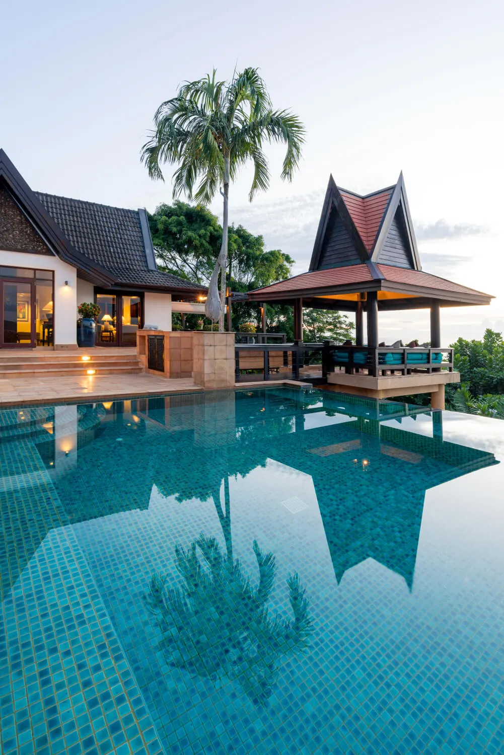 The villa reflected in the pool in the evening
