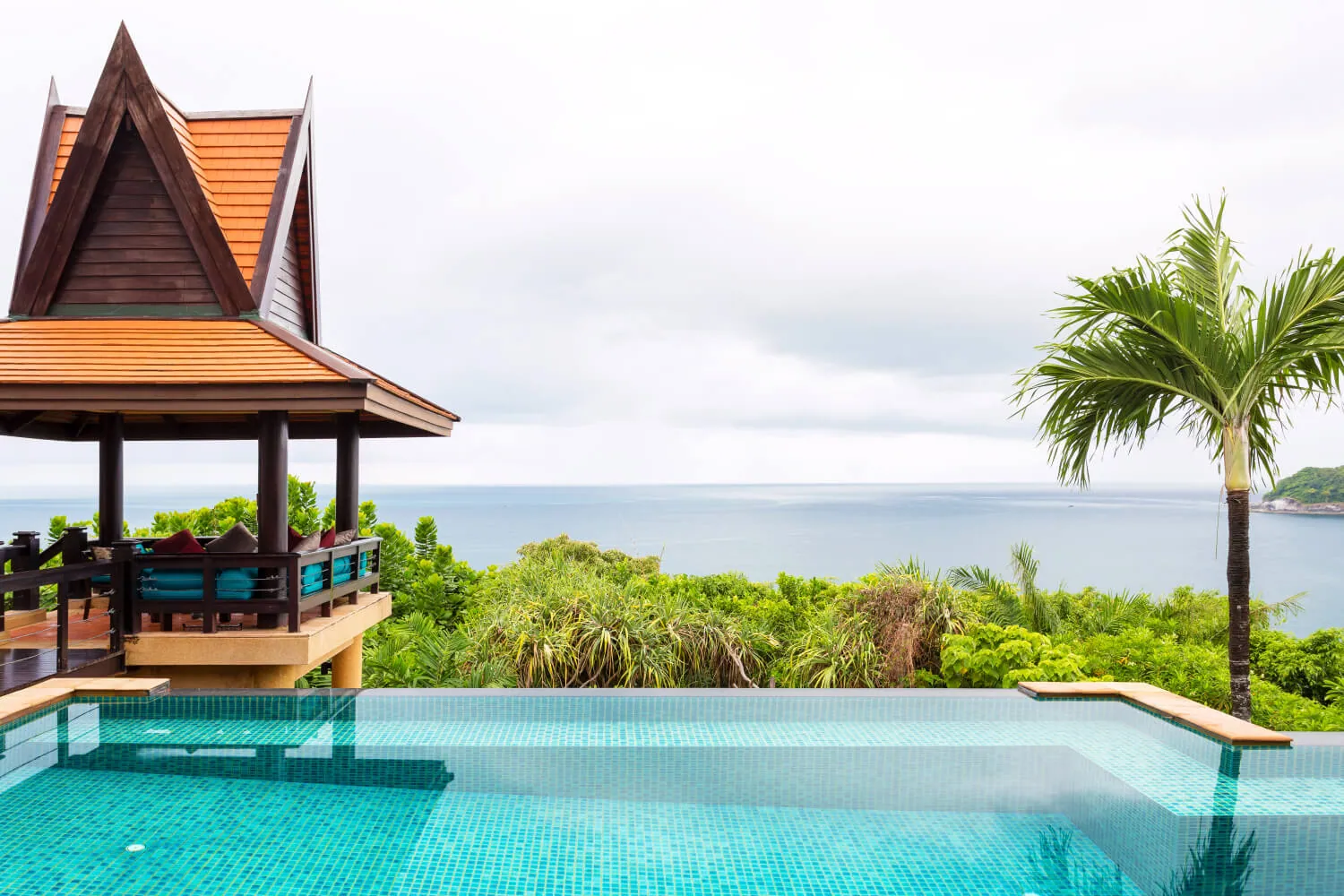 The sala on the pool edge with the Andaman Sea beyond