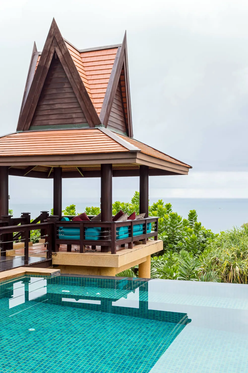 The traditional covered sala standing over the pool with the Andaman Sea behind